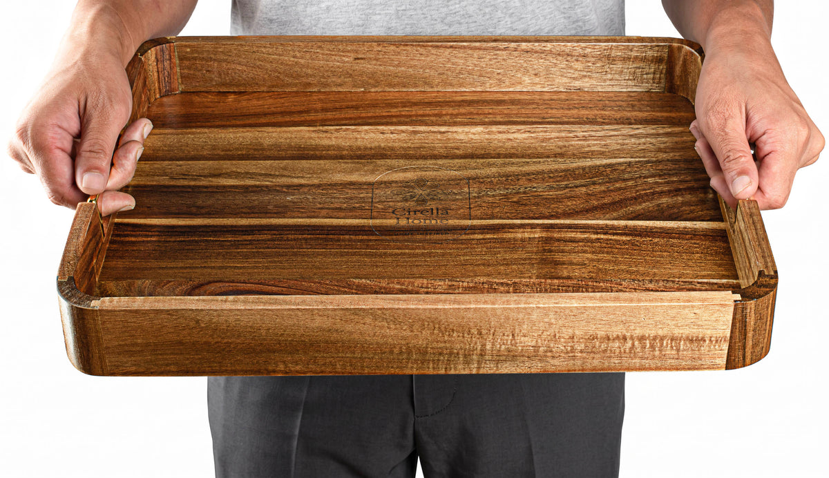 Acacia tray held in two hands to show its size